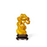 A CHINESE YELLOW GLASS SCHOLAR’S ROCK, QING DYNASTY OR LATER Of an irregular natural form, raised on