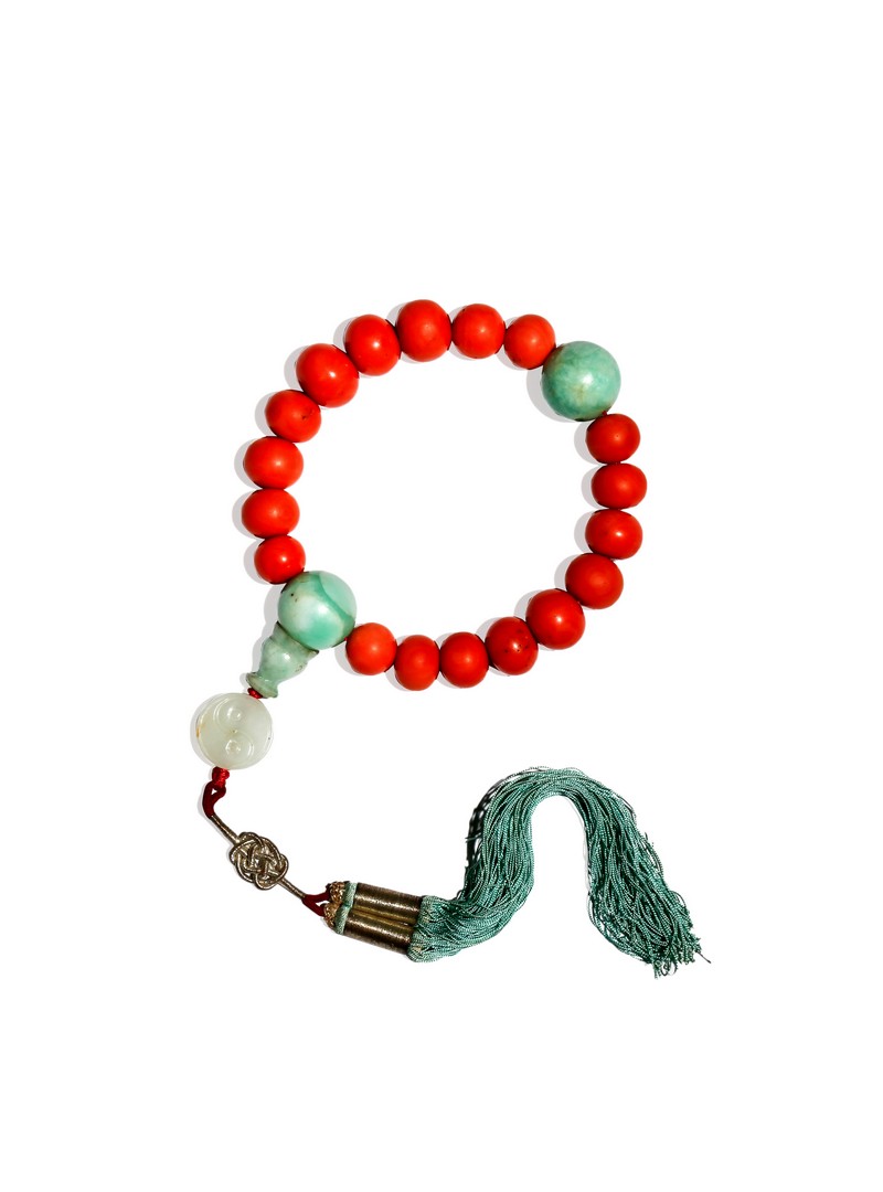 A CHINESE CORAL AND JADEITE ROSARY BRACELET, QING DYNASTY The graduated coral beads divided by two