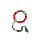 A CHINESE CORAL AND JADEITE ROSARY BRACELET, QING DYNASTY The graduated coral beads divided by two