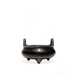 A CHINESE BRONZE TRIPOD INCENSE BURNER, 19TH CENTURY The compressed circular body raised on three