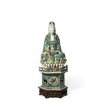 A CHINESE FAMILLE VERTE MODEL OF GUANYIN, KANGXI 1662-1722 Seated wearing draped foliate robes, a