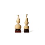 † TWO CHINESE IVORY MINIATURE MODELS OF GOURDS, 19TH CENTURY Each carved with a stalk forming the
