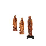 † THREE CARVED IVORY FIGURES, 19TH CENTURY Each standing wearing draped flowing robes, one holding a