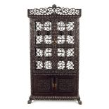 A CHINESE HARDWOOD DISPLAY CABINET, 1ST HALF 20TH CENTURY Elaborately carved with flowers and