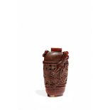 A CHINESE HORN SNUFF BOTTLE, QING DYNASTY The ovoid body carved with a band containing taotie masks,