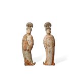 TWO CHINESE POTTERY FIGURES OF COURT LADIES, TANG DYNASTY 618-907 AD Each standing wearing flowing