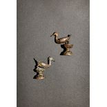 A PAIR OF CHINESE SMALL SILVER COLOURED METAL MODELS OF DUCKS, 19TH CENTURY Each standing on a