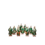 ELEVEN CHINESE POTTERY STANDING FIGURES, MING DYNASTY Variously modelled, some wearing hats and