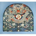 A CHINESE SILK PANEL, 18TH CENTURY Taken from a blue silk robe, depicting a confronting dragon