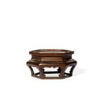 A CHINESE BRONZE HEXAGONAL STAND, 18TH/19TH CENTURY Raised on six curved legs, each with a ruyi-