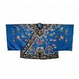 A CHINESE BLUE SILK JACKET, LATE QING DYNASTY Decorated with figural roundels and flowers,