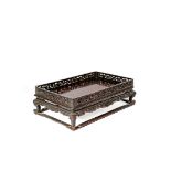 A SMALL CHINESE HARDWOOD STAND OR TRAY, QING DYNASTY The rectangular top with reticulated stylized