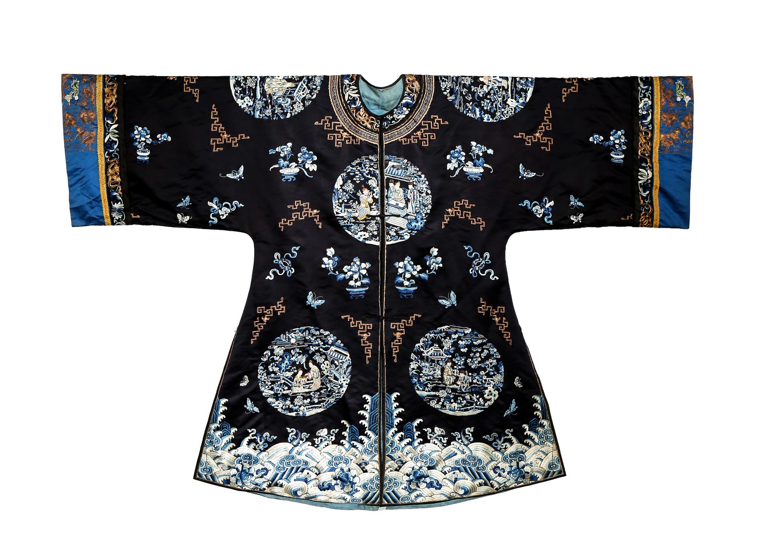 A CHINESE DARK BLUE SILK SURCOAT, LATE QING DYNASTY Decorated with figural roundels, vases of