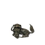 A MASSIVE CHINESE BRONZE MODEL OF A BUDDHIST LION DOG, 17TH CENTURY Crouching with a brocade ball