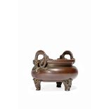 A CHINESE BRONZE TRIPOD INCENSE BURNER, 18TH/19TH CENTURY The compressed circular body raised on