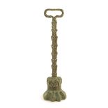 A Victorian brass lion's paw doorstop, with an open handle and a leaf cast stem, 40cm high.