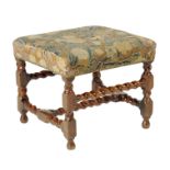 A walnut stool, the stuffed-over seat covered in floral tapestry on spiral twist and block supports,