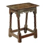 A Charles II oak joined stool, the moulded edged top above bicuspid carved friezes on ring turned