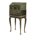 An early 18th century black japanned bureau on stand, decorated in raised gilt with chinoiserie