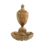 An Italian marble water urn, with a lead lining and with a brass tap above a shell shaped bowl, 65.