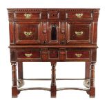 A late 17th century oak chest on a later stand, with a dentil moulding above one shallow and one