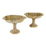 A pair of painted wood faux marble tazzas, each with a scalloped bowl on a fluted spreading foot,