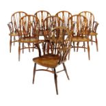 A set of eight early 19th century yew and beech low back Windsor armchairs in the manner of the