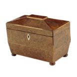 A Regency burr yew tea caddy, of sarcophagus shape, inlaid with boxwood stringing, the interior with