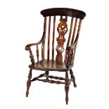 A Victorian fruitwood and elm Windsor armchair, the slat back with a carved and pierced central