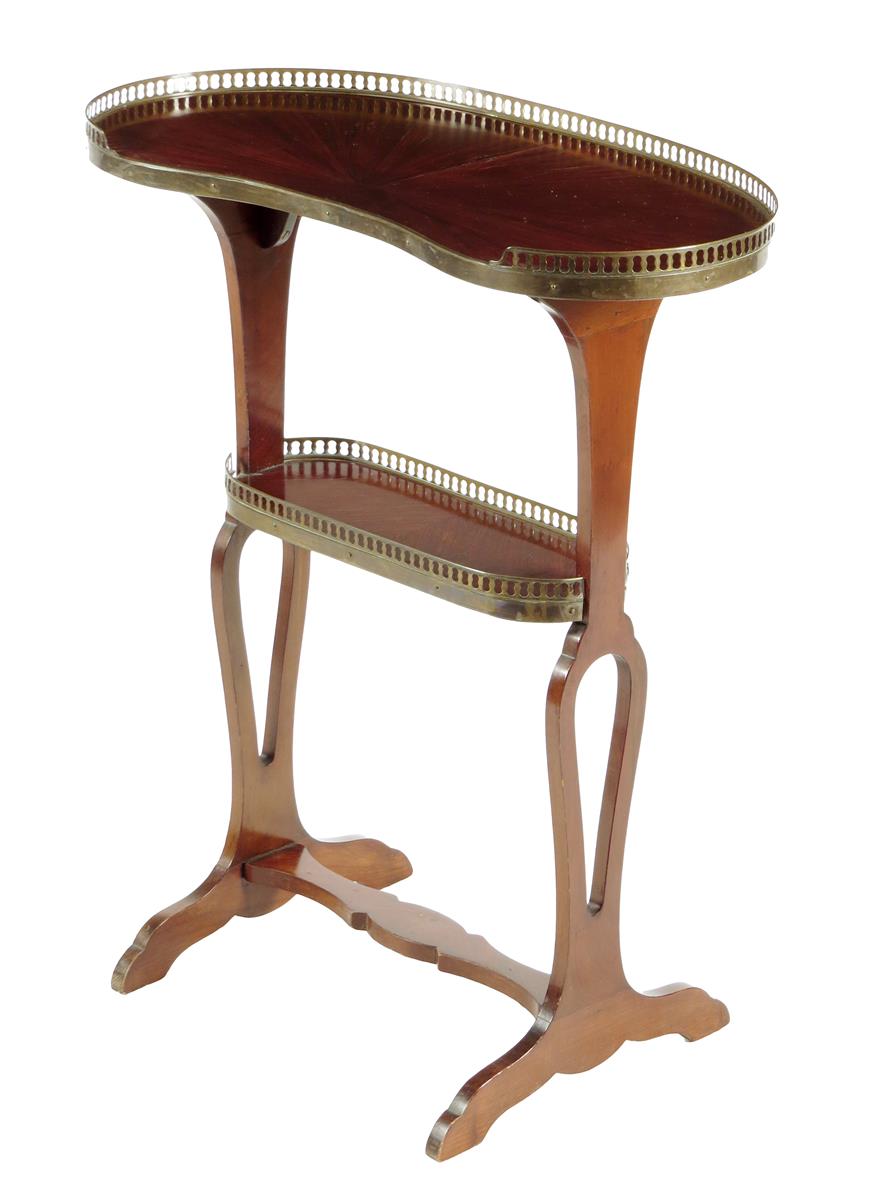 A French kingwood two tier occasional table by Perol, with a kidney shaped top and pierced brass