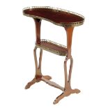 A French kingwood two tier occasional table by Perol, with a kidney shaped top and pierced brass