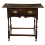 A Queen Anne oak side table, the boarded top above a frieze drawer and a wavy edge apron on baluster