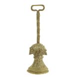 A Victorian brass wheat sheaf doorstop, with an open handle and a reeded stem, 40.5cm high.