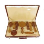 A 1930's French blonde tortoiseshell dressing table set, in a red leather case fitted with five