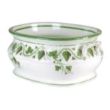 A 19th century Wedgwood pottery footbath, decorated in green with a vine leaves and grapes, with a