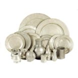 A collection of pewter, comprising: two chargers, six platters two with triad owner's initials,