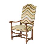An 18th century walnut open armchair, the arched padded back and seat covered in Bargello style