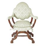 A William and Mary style walnut armchair, with a padded back, seat and armrests on moulded 'X' frame