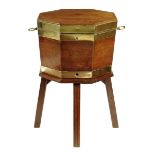 A George III mahogany and brass bound octagonal cellaret on stand, the hinged lid revealing a vacant