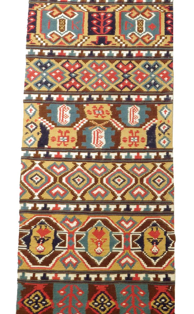 A Swedish flat weave tapestry runner, with panels of geometric designs, figures, dated '1883 and