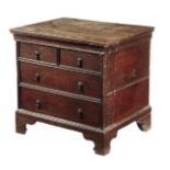 An early 18th century oak close stool, the hinged lid revealing a vacant interior, with false drawer