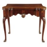 A George II red walnut card table, the serpentine edge fold-over top revealing a baize lined surface