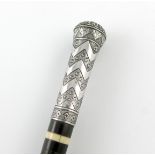 λ A Persian silver-mounted walking cane, tapering circular form, with niello chevron decoration, the