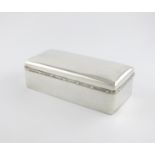 An Edwardian silver cigarette box, by William Comyns, London 1902, rectangular form, the solid cover