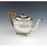 A George III silver tea pot, by William Hall, London 1805, oblong form, scroll handle, flush-