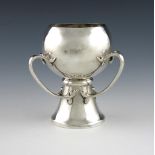 An Edwardian silver three-handled tyg, by Wakely and Wheeler, London 1902, circular bowl, bifurcated