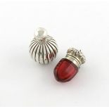 A 19th century silver-mounted glass vinaigrette, unmarked, faceted red glass body, the hinged