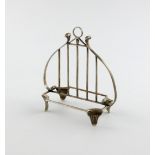 An Edwardian silver letter rack/toast rack, by William Comyns, London 1906, lyre form, central