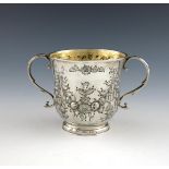 A Queen Anne silver two-handled cup, marks worn, London 1706, circular form, embossed foliate