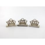 A set of three Edwardian silver menu card holders, by Grey & Co, London 1906, in the form of Naval